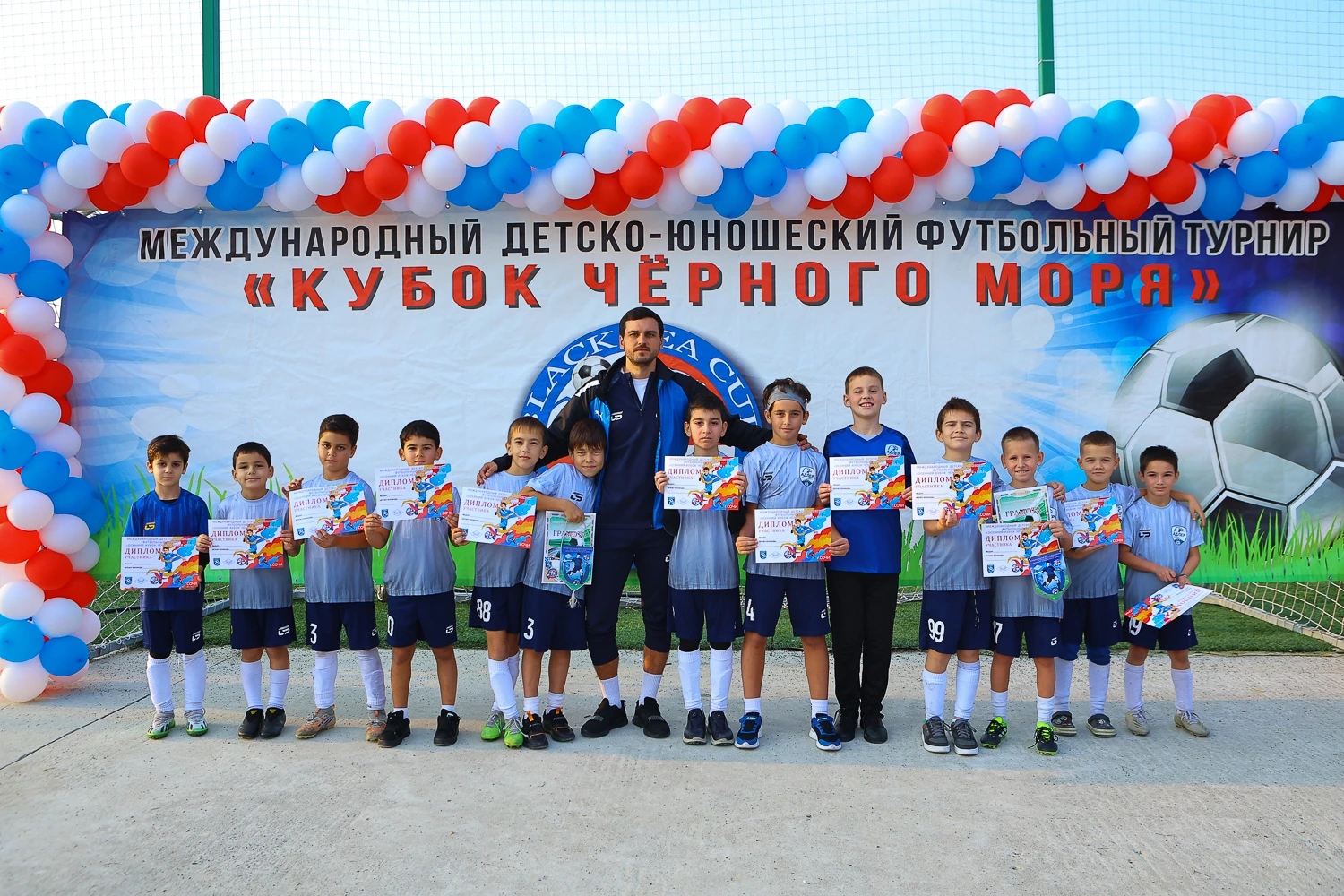 A youth football team celebrating a goal.