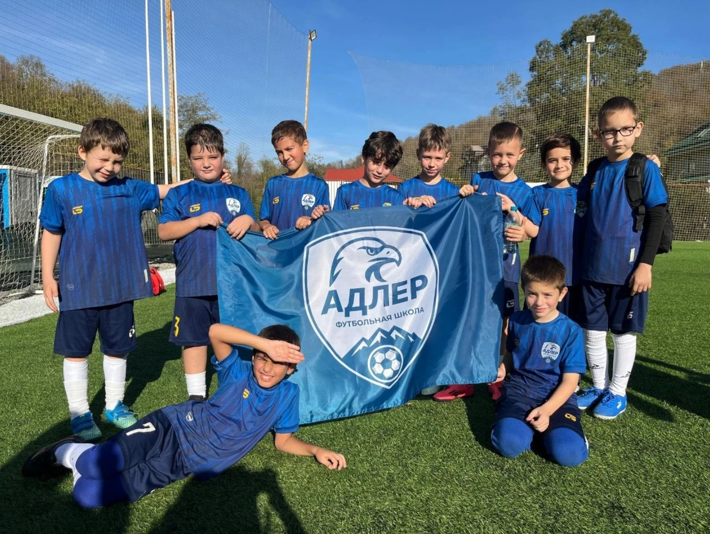 Children playing football in a sunny day.